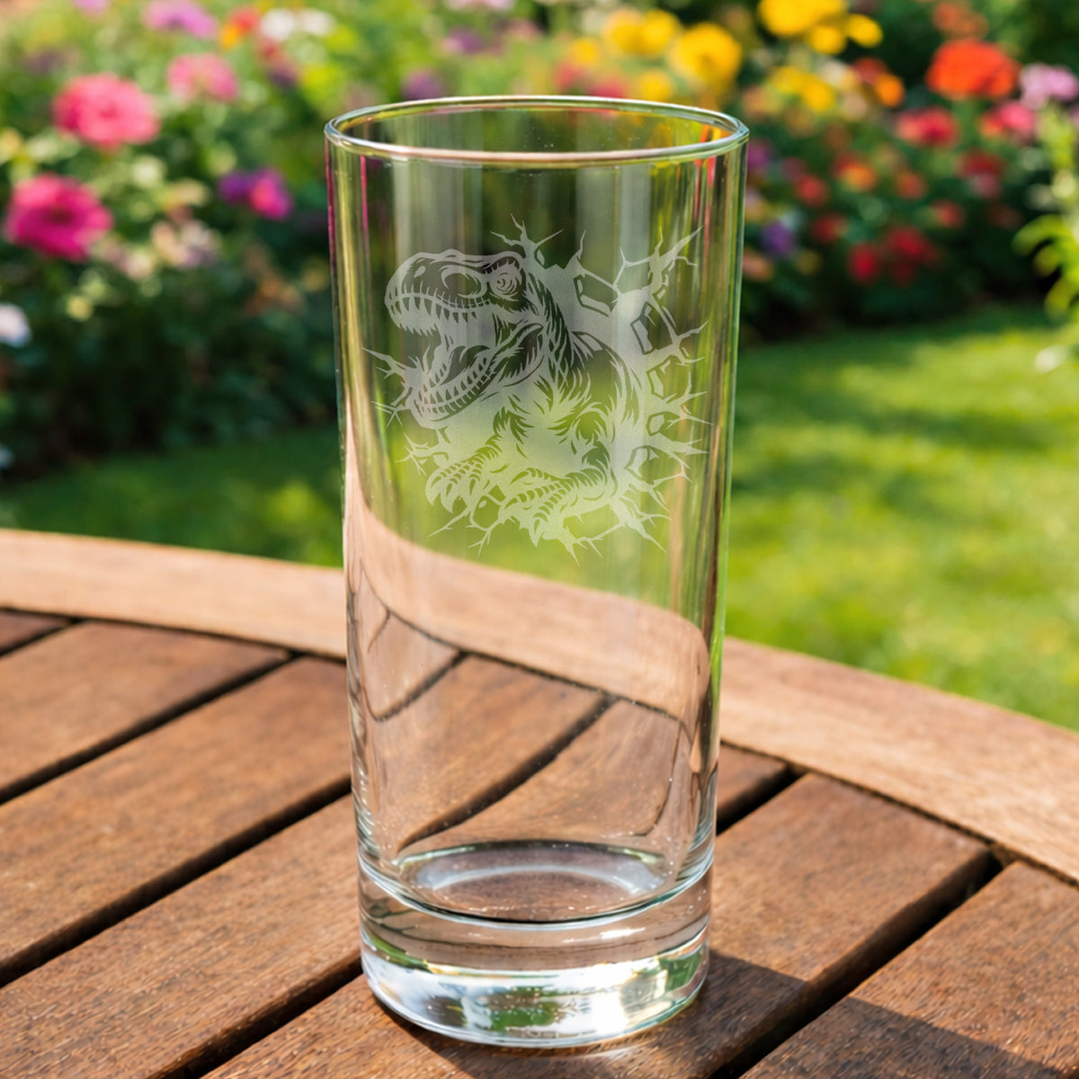 T-Rex dinosaur breaking through a wall laser etched onto a glass highball 